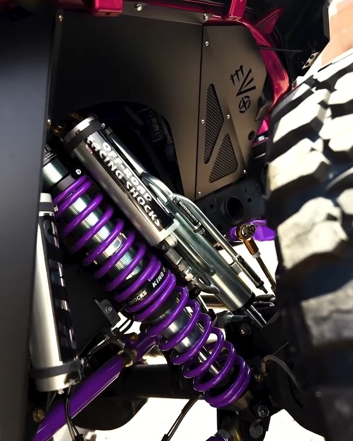 Purple King coilover and control arm on the front suspension of a lifted Jeep