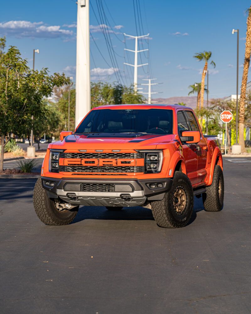 Orange Ford Raptor on all-terrain tires