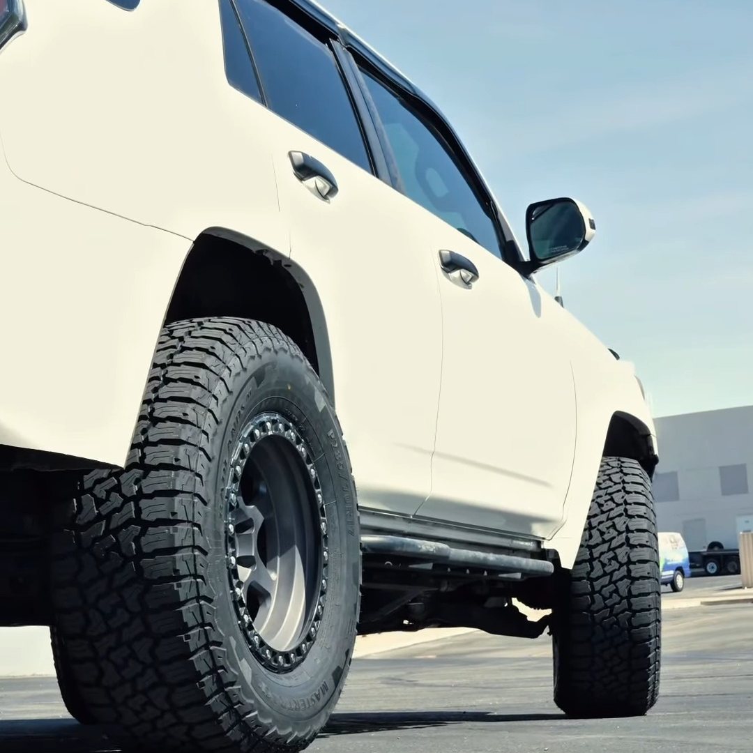 White Toyota 4Runner on new off-road wheels and all-terrain tires