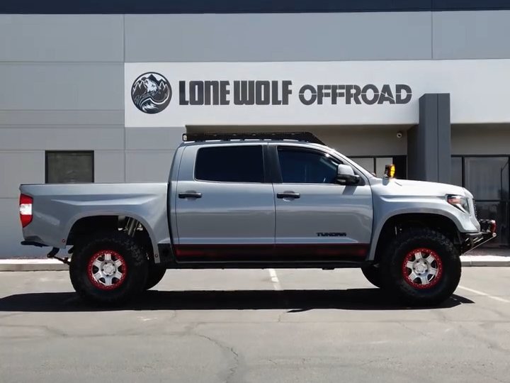 Silver Toyota Tundra on red aftermarket wheels parked outside the Lone Wolf Offroad shop in Henderson, Nevada